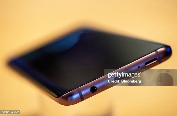 5mm headphone jack, left, sits next to a USB-C charging port, center, and a stereo speaker port on the underside of the Galaxy S9+ smartphone during...