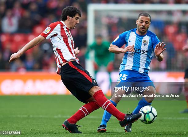Medhi Lacen of Malaga CF competes for the ball with Mikel San Jose of Athletic Club during the La Liga match between Athletic Club Bilbao and Malaga...