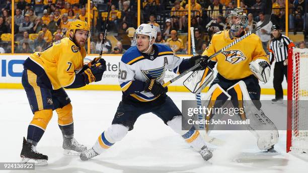 Alexander Steen of the St. Louis Blues battles between Yannick Weber and Pekka Rinne of the Nashville Predators during an NHL game at Bridgestone...