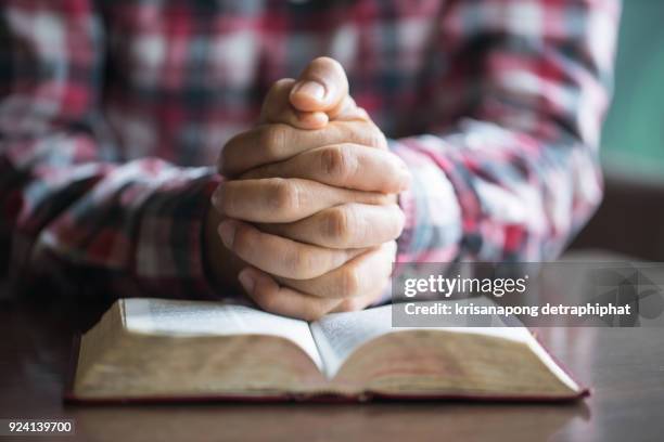 a man reading the holy bible. - geestelijken stockfoto's en -beelden