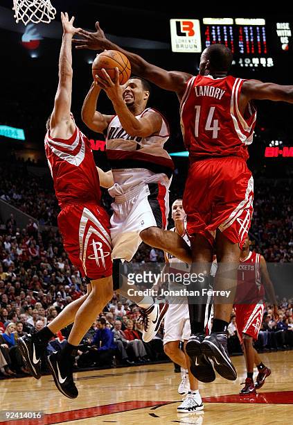 Brandon Roy of the Portland Trail Blazers drives against Carl Landry and David Andersen of the Houston Rockets during the season opener on October...