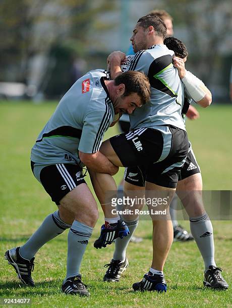 Andrew hore tackles Luke McAlister during a New Zealand All Blacks training session at Kubota Spears Rugby Field in Chiba on October 28, 2009 in...