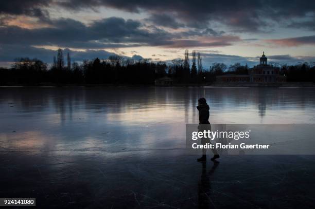 Girl walks on a frozen lake on February 25, 2018 in Potsdam, Germany.