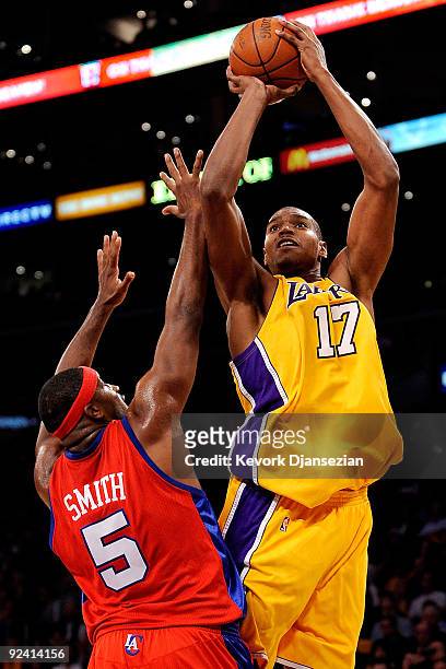 Andrew Bynum of the Los Angeles Lakers shoots over Craig Smith of the Los Angeles Clippers during the season opening game at Staples Center on...