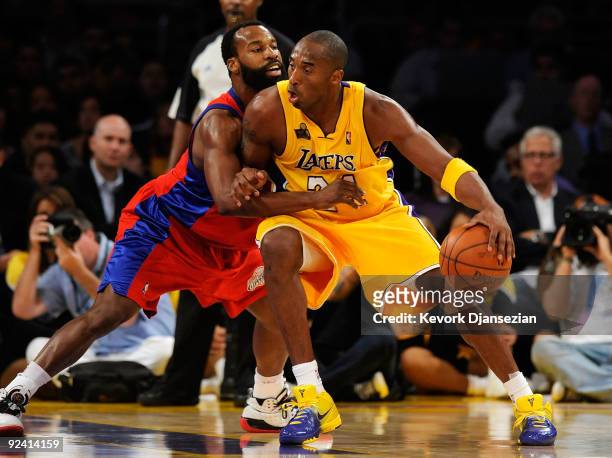 Kobe Bryant of the Los Angeles Lakers goes up against Baron Davis of the Los Angeles Clippers during the season opening game at Staples Center on...