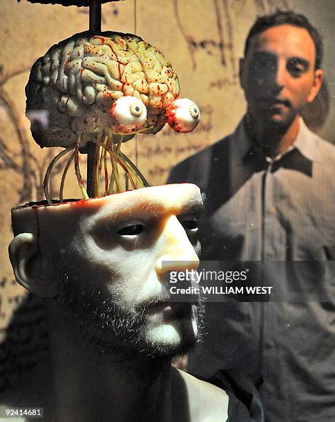 Massimo Ingrosso inspects a life-like dissection of a head to show the head and cranial nerves at a Leonardo Da Vinci exhibition titled 'Anatomy to...