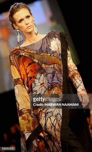 Model presents a traditonal "jalabiya" from the Beenas & B'jouel collection by Indian designers during a fashion show in the Gulf emirate of Dubai...