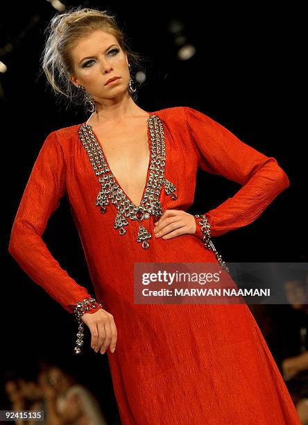 Model presents a traditonal "jalabiya" from the Beenas & B'jouel collection by Indian designers during a fashion show in the Gulf emirate of Dubai...