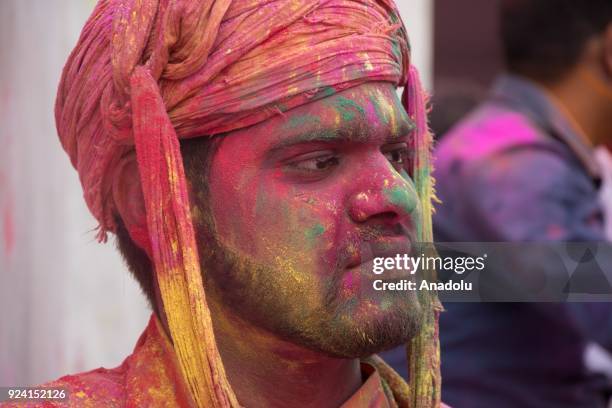 Indians celebrate Holi, the spring festival of colours, during a traditional gathering at Nandbaba temple in Nandgaon village of Mathura district in...