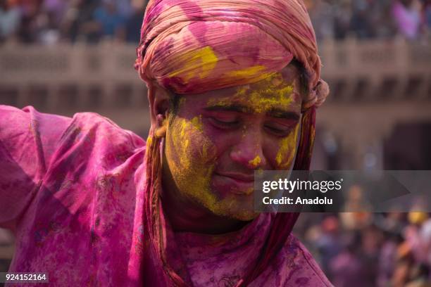 Indians celebrate Holi, the spring festival of colours, during a traditional gathering at Nandbaba temple in Nandgaon village of Mathura district in...