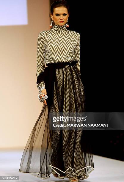Model presents a traditonal "jalabiya" from the Beenas & B'jouel collection by Indian designers during a fashion show in the Gulf emirate of Dubai...
