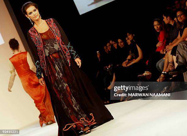 Model presents a traditonal "jalabiya" from the Beenas & B'jouel collection by Indian designers during a fashion show in the Gulf emirate of Dubai...