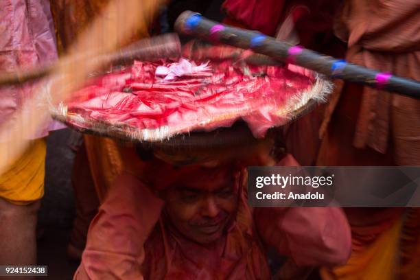 Indian women beat men with stick during celebration of Lathmar Holi in Nandgaon village of Mathura district in Uttar Pradesh, India on February 25,...