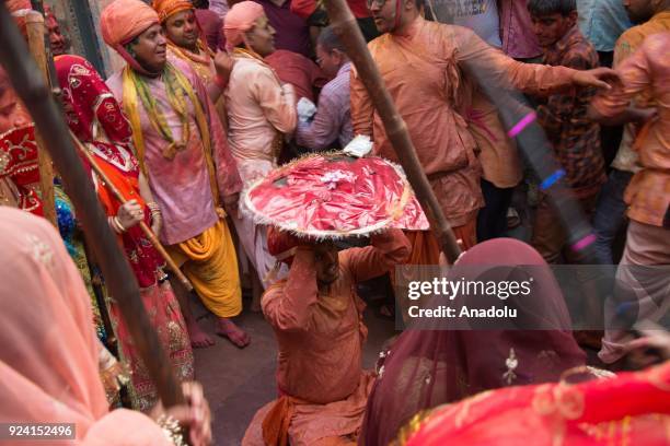 Indian women beat men with stick during celebration of Lathmar Holi in Nandgaon village of Mathura district in Uttar Pradesh, India on February 25,...