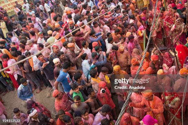 Indian women beat men with stick during celebration of Lathmar Holi in Nandgaon village of Mathura district in Uttar Pradesh, India on February 25,...