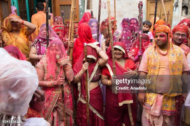 Indian women beat men with stick during celebration of Lathmar Holi in Nandgaon village of Mathura district in Uttar Pradesh, India on February 25,...