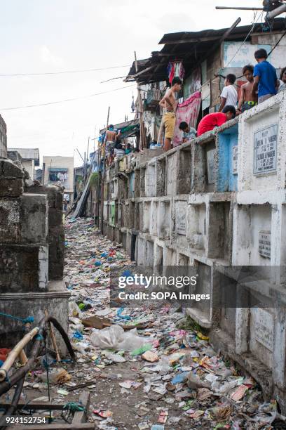 House and local people seen in navotas cemetery slum. In the center of Pasay District of Metro Manila is a cemetery where over 10,000 deceased people...