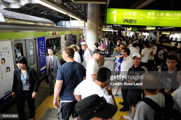 Players join the crowd to catch the tube on a scenic tour around Tokyo following a New Zealand All Blacks training session at Kubota Spears Rugby...