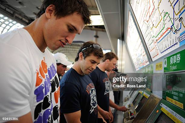 Anthony Boric, Conrad Smith and Wyatt Crocket buy tickets to catch the tube on a scenic tour around Tokyo following a New Zealand All Blacks training...