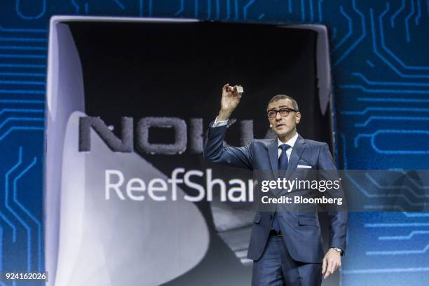 Rajeev Suri, president and chief executive officer of Nokia Oyj, presents the ReefShark chipset during a special event ahead of the Mobile World...