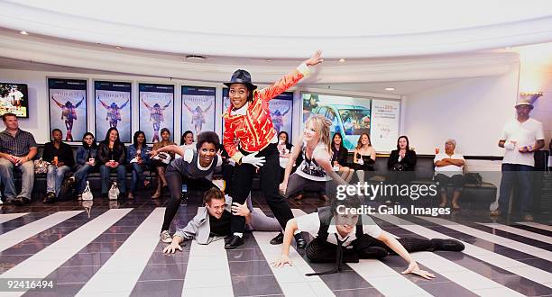 Fans dance to the music of Michael Jackson at the South African premiere of "This is It" at the Ster Kinekor cinemas in Fourways on October 28, 2009...