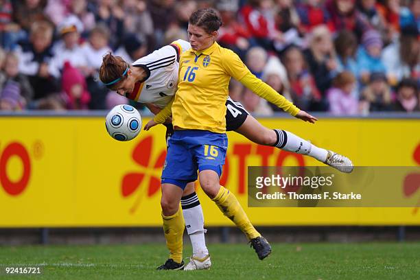 Stefanie Mirlach BACK) of Germany and Susanne Moberg of Sweden tackle for the ball during the women's international friendly match between Germany...