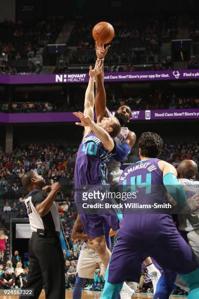 Cody Zeller of the Charlotte Hornets and Andre Drummond of the Detroit Pistons during a jump ball on February 25, 2018 at Spectrum Center in...