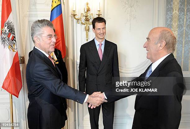 Liechtenstein's Prince Alois watches President of Switzerland Hans-Rudolf Merz welcomed by Austrian President Heinz Fischer as they meet in Esterhazy...