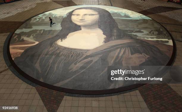 Luke Wharton-Jones, aged eight, runs across the world's biggest copy of the Mona Lisa during a photocall for its unveiling on October 28, 2009 in...