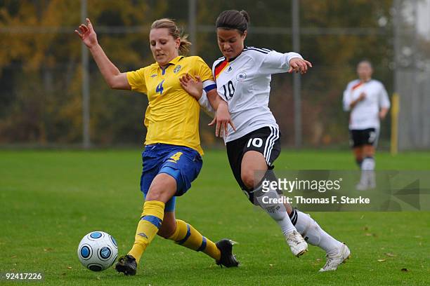 Emma Wilhelmsson of Sweden and Dzsenifer Marozsan of Germany tackle for the ball during the Women's International friendly match between Germany U20...