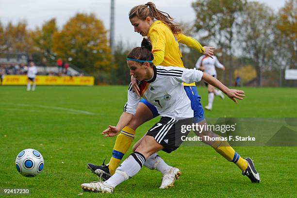 Jessica Wich of Germany and Emma Berglund of Sweden tackle for the ball during the Women's International friendly match between Germany U20 and...