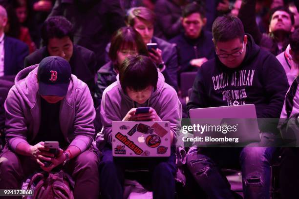 Attendees browse smartphones and laptops during a Samsung Electronics Co. 'Unpacked' launch event ahead of the Mobile World Congress in Barcelona,...