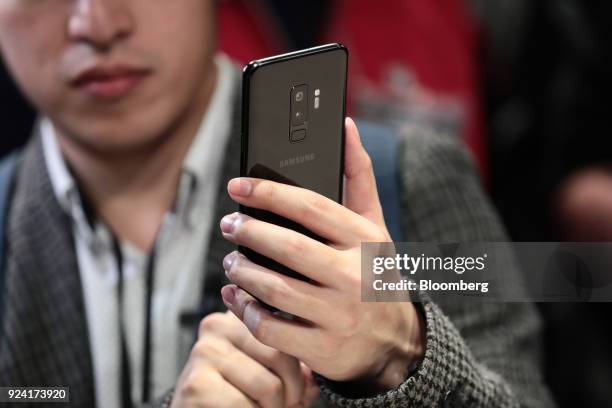 An attendee tests a Galaxy S9 smartphone during a Samsung Electronics Co. 'Unpacked' launch event ahead of the Mobile World Congress in Barcelona,...