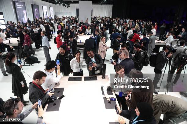 Attendees look at Galaxy S9 smartphones on display during a Samsung Electronics Co. 'Unpacked' launch event ahead of the Mobile World Congress in...
