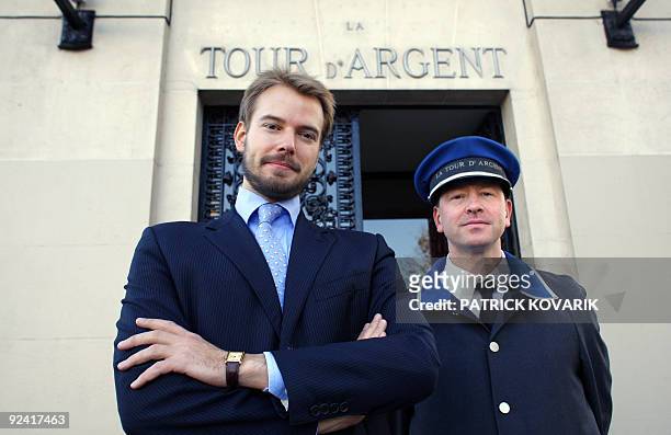 Andre Terrail, director of Paris' famed 16th century eatery, the Tour d'Argent poses with an employee on October 27, 2009 in front of the restaurant....