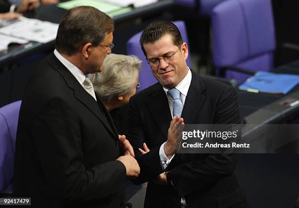 Minister of Work and Social Issues designate Franz Josef Jung chats with Defense Minister designate Karl-Theodor zu Guttenberg at the Bundestag on...