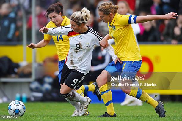 Josefin Johansson and Emma Wilhelmsson of Sweden tackle Svenja Huth of Germany during the Women's International friendly match between Germany U20...
