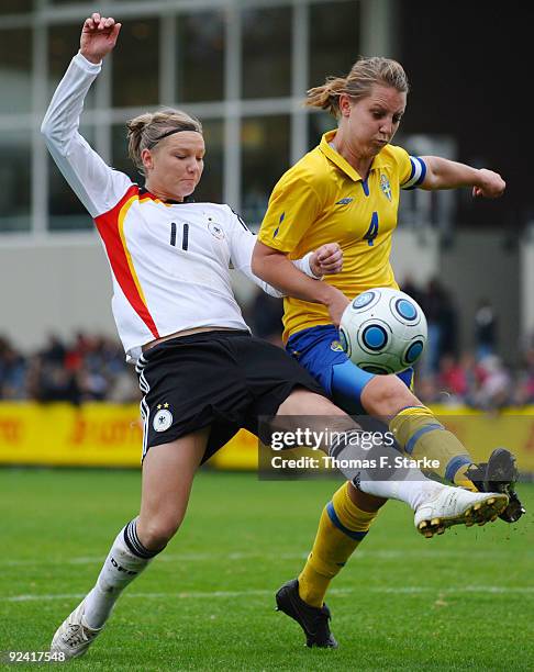 Alexandra Popp of Germany and Emma Wilhelmsson of Sweden tackle for the ball during the Women's International friendly match between Germany U20 and...