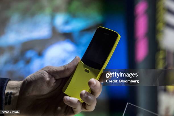 An attendee holds a yellow Nokia 8110 4G smartphone, manufactured by HMD Global Oy, during a launch event ahead of the Mobile World Congress in...