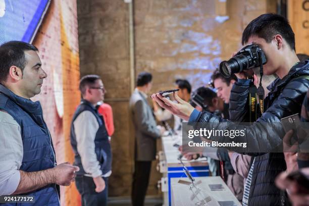 An attendee films a Nokia 8 Sirocco smartphone, manufactured by HMD Global Oy, during a launch event ahead of the Mobile World Congress in Barcelona,...