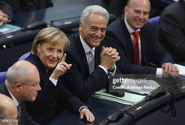German Chancellor designate Angela Merkel gestures as Transport Minister designate Peter Ramsauer smiles prior to her re-election at the Bundestag on...