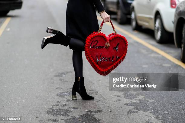 Caroline Caro Daur wearing red bag with print Queen of heart is seen outside Dolce & Gabbana during Milan Fashion Week Fall/Winter 2018/19 on...