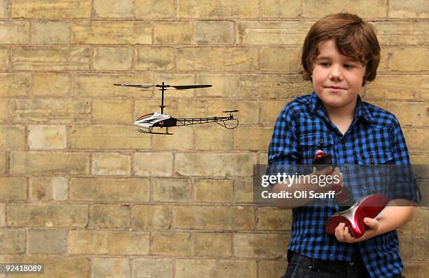 Seven-year-old Drew, plays with a remote controlled helicopter made by Bladez Toys at the 'Dream Toys' fair of predicted top selling toys for...
