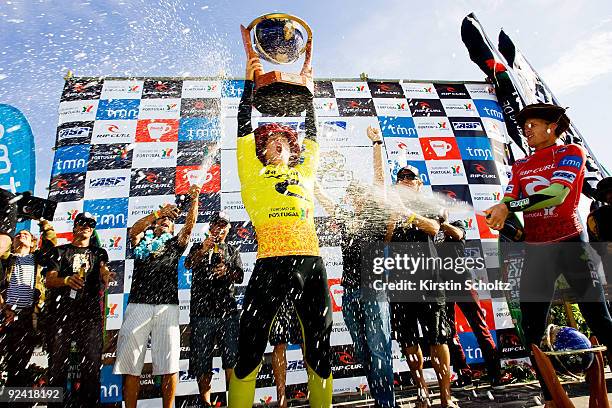 Rip Curl Pro Search Champion Mick Fanning of Australia holds up his trophy while runner-up Bede Durbidge of Australia sprays him with champagne...