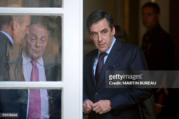 French Prime minister Francois Fillon escorts former French Prime ministers Alain Juppe and Michel Rocard on october 28, 2009 after a meeting at the...