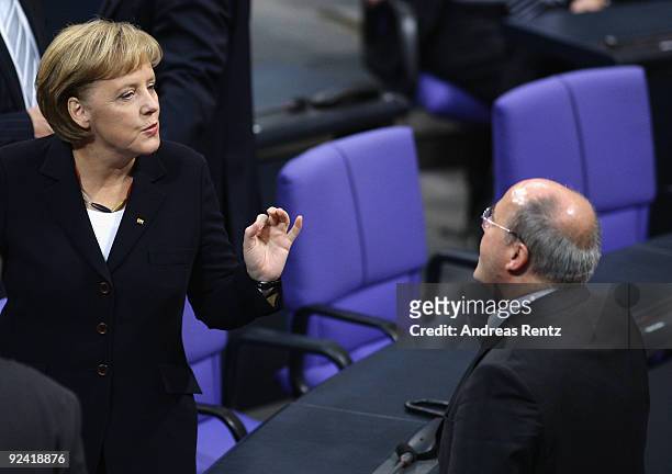 German Chancellor Angela Merkel chats with Gregor Gysi, Chairman of the German left-wing party Die Linke faction at the Bundestag on October 28, 2009...