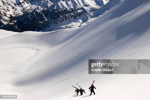 three skiers climbing a steep mountain - pirin mountains stock pictures, royalty-free photos & images