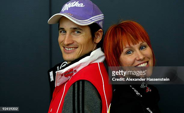 Biathlon athlete Kati Wilhelm poses with Ski Jumper Martin Schmitt after a press conference at the German athlete Winter kit preview at the adidas...