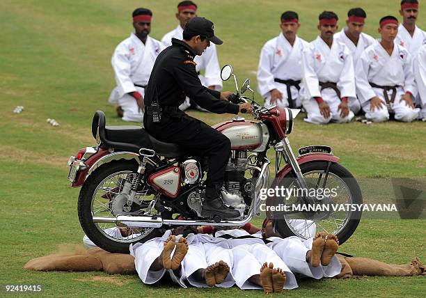 National Security Guards commandos display their martial-arts skills during a function to celebrate the 25th NSG Raising day in Gurgaon, around 50...