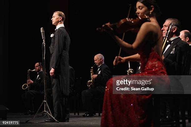 German singer Max Raabe performs with his Palast Orchester orchestra at a photocall for the release of his new DVD "Heute Nacht Oder Nie" at...